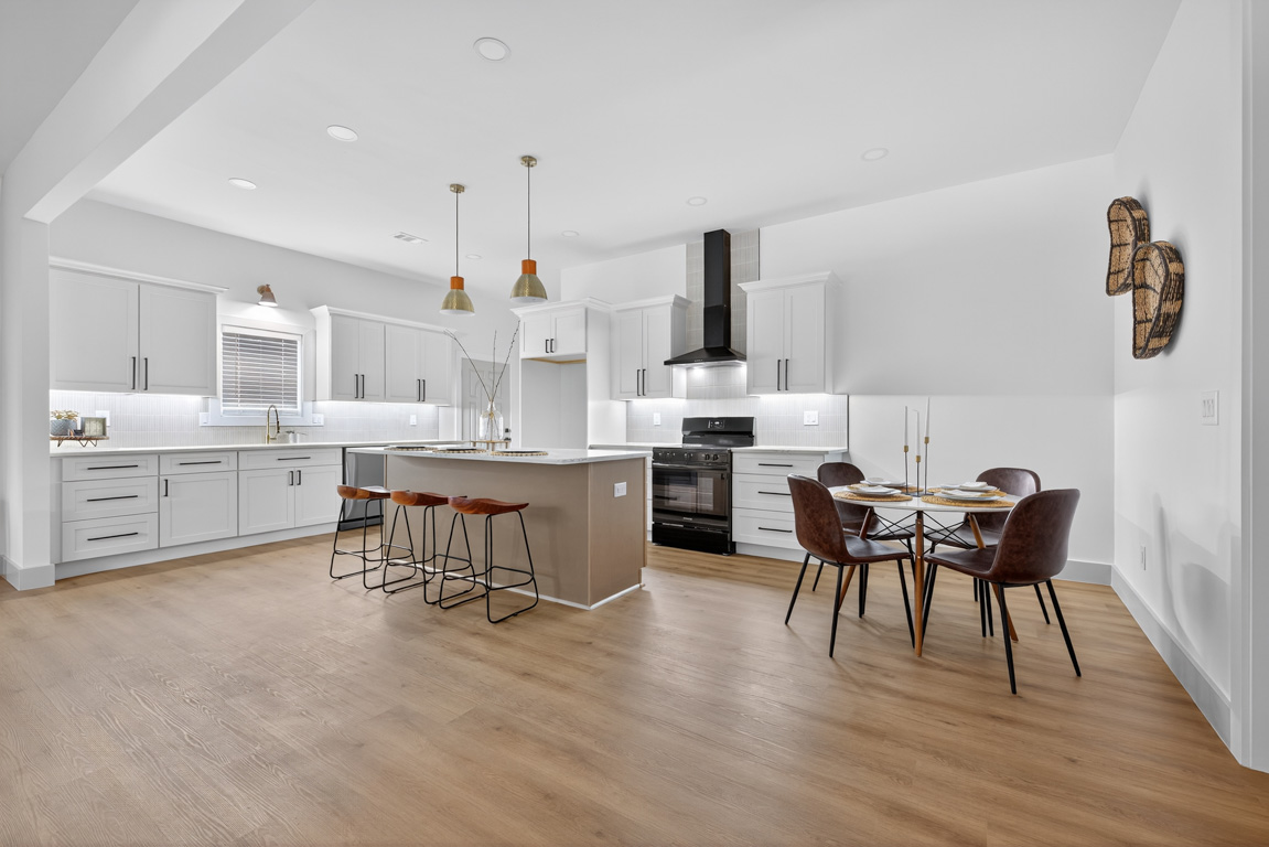 Modern farmhouse kitchen remodel with large island and white cabinetry in Braselton, GA