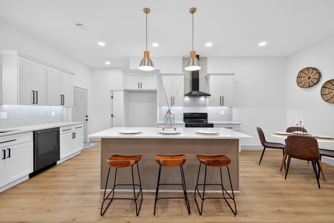Kitchen renovation with quartz countertop island and warm wood flooring in Buford, GA